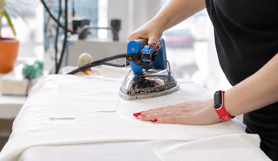Pressing the gown in the workshop