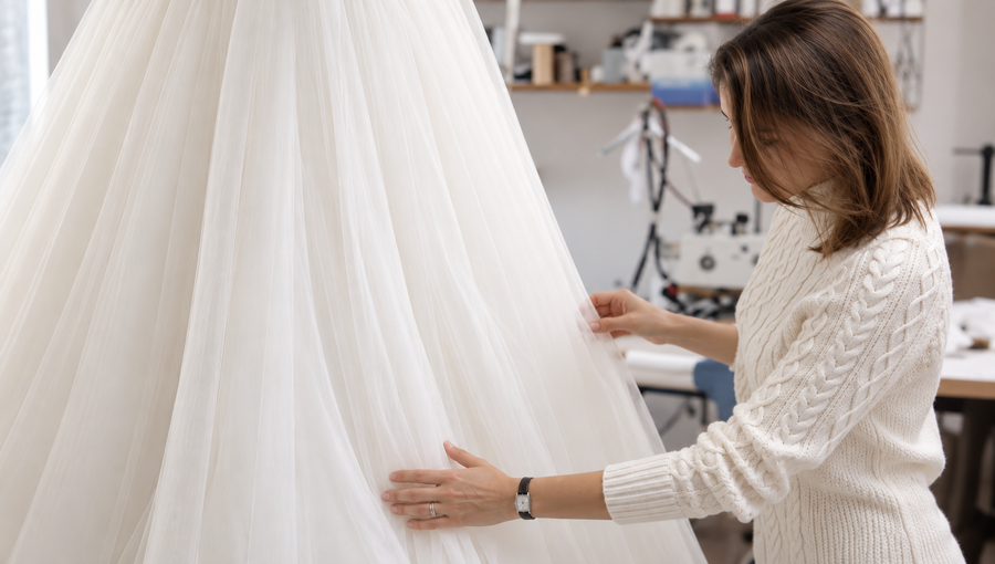 Kate checking a finished gown in the workshop